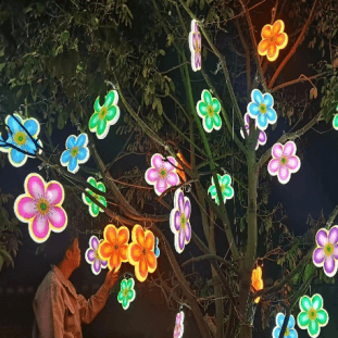 Park hanging trees with bright plum blossom shaped landscape lights